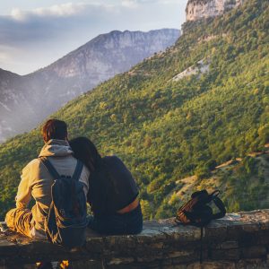 couples sitting in while facing mountain 1483024