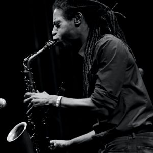 monochrome photo of man playing saxophone 1813157
